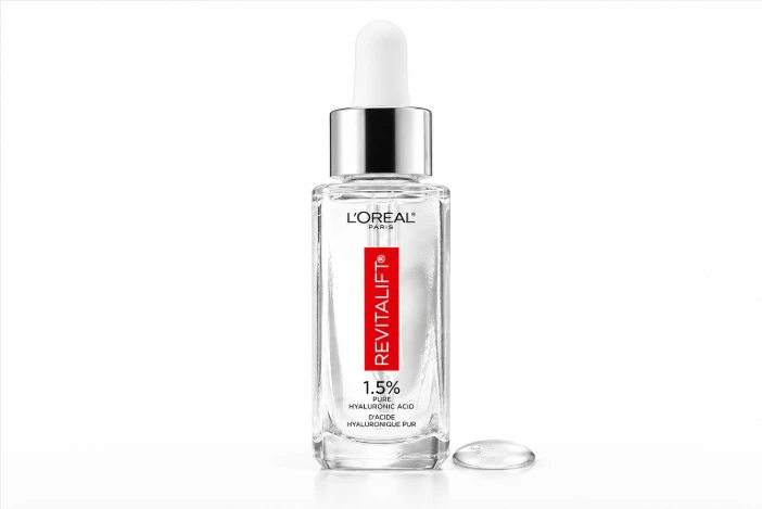 L’Oréal Paris Revitalift 1.5% Pure Hyaluronic Acid Serum with a clear serum droplet on a white background.