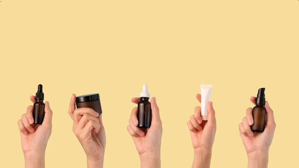 Five hands holding skincare products representing a simple skincare routine order